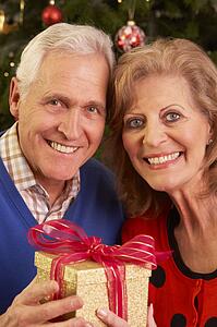 Senior Couple Exchanging Christmas Gifts
