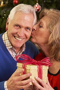 Senior Couple Exchanging Christmas Gifts