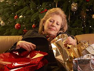 Tired Senior Woman Returning After Christmas Shopping Trip