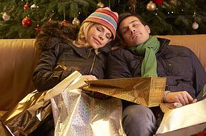 Tired Couple Returning After Christmas Shopping Trip