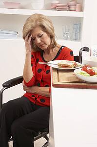 Distressed Disabled Senior Woman Making Sandwich In Kitchen