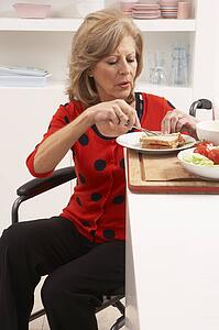 Disabled Senior Woman Making Sandwich In Kitchen