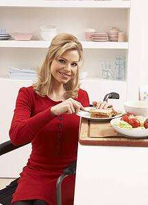 Disabled Woman Making Sandwich In Kitchen