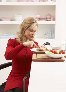 Disabled Woman Making Sandwich In Kitchen