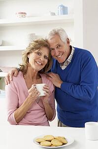 Senior Couple Enjoying Hot Drink In Kitchen