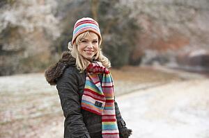 Couple On Romantic Winter Walk Through Frosty Landscape
