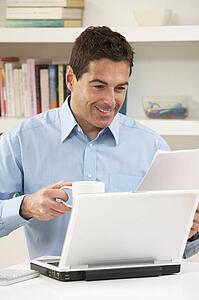 Man Working From Home Using Laptop