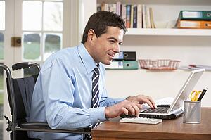 Man Working From Home Using Laptop