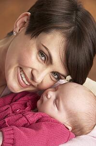Portrait Of Mother With Newborn Baby At Home