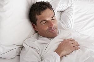 Man Sleeping Peacefully In Bed