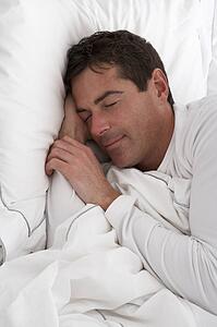 Man Sleeping Peacefully In Bed