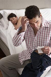 Suspicious Husband Finding Receipt In Wife's Pocket Whilst She Sleeps