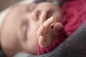 Close Up Of Hand Of Sleeping Newborn Baby Girl