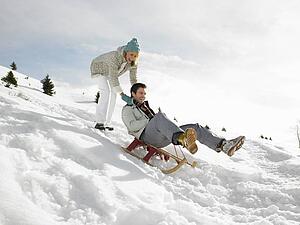 Young Couple Sledding