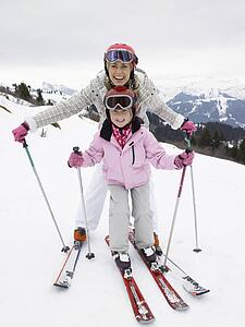 Young Mother And Daughter On Ski Vacation