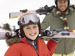Pre-teen Boy With Father On Ski Vacation