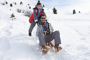 Young Father And Son Sledding