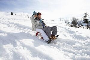Young Couple Sledding