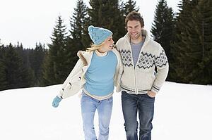Young Couple In Alpine Snow Scene