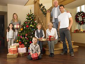 Family with gifts around the Christmas tree