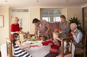 Family serving Christmas dinner