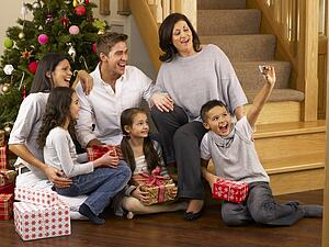 Hispanic family taking photos at Christmas