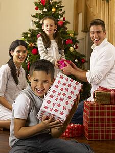 Hispanic family exchanging gifts at Christmas