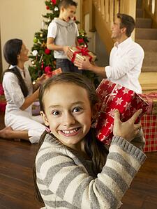 Hispanic family exchanging gifts at Christmas