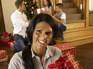 Hispanic family exchanging gifts at Christmas