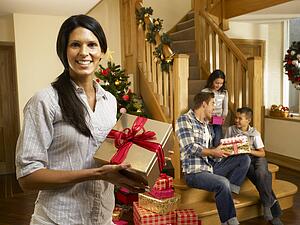 Hispanic family exchanging gifts at Christmas