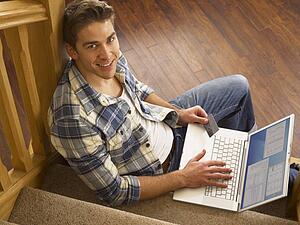 Young Hispanic man shopping online