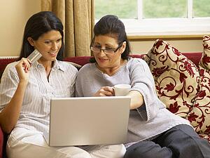 Hispanic mother and daughter shopping online