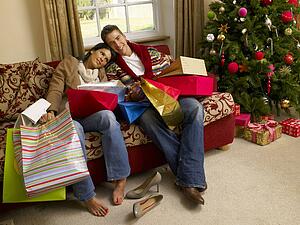 Young Hispanic couple resting after Christmas shopping