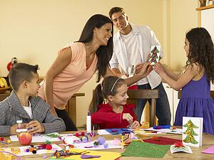 Hispanic family making Christmas cards