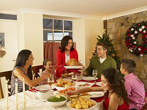 Hispanic family serving Christmas dinner