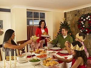 Hispanic family having Christmas dinner