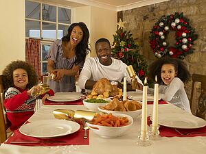 Mixed race family having Christmas dinner