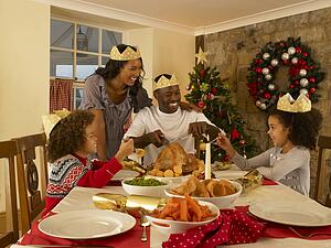 Mixed race family having Christmas dinner