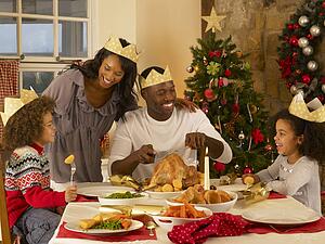 Mixed race family having Christmas dinner