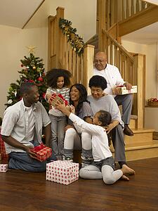 African American family exchanging Christmas gifts