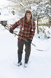Young man clearing snow