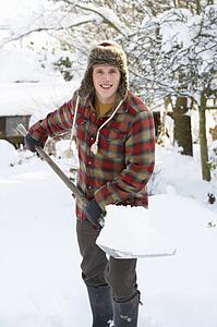 Young man clearing snow