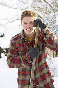 Young man clearing snow
