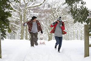 Young couple having snowball fight