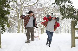 Young couple having snowball fight