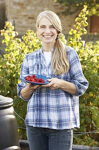 Woman with home-grown fruit