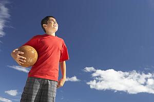 Teenage boy holding football