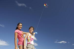 Teenage girls flying a kite