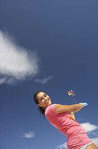 Teenage girl flying a kite