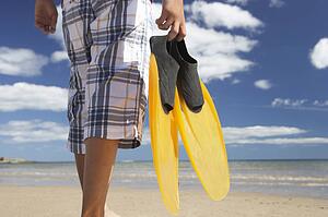 Teenage boy on beach with flippers
